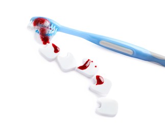 Decorative teeth and toothbrush with blood on white background. Gum inflammation