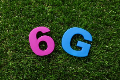 6G technology, Internet concept. Number and letter on green grass, flat lay