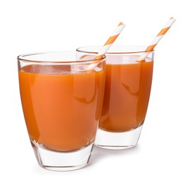 Two glasses of carrot juice with straws on white background
