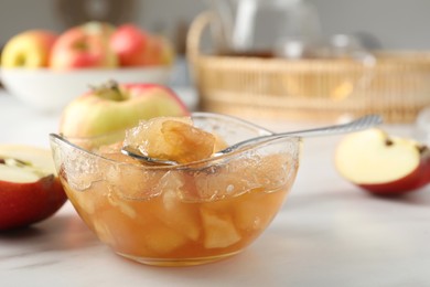 Delicious apple jam and fresh fruits on white table, closeup