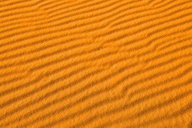 Closeup view of orange sand dune in desert as background