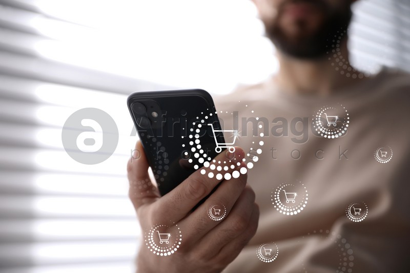 Delivery concept. Man using modern mobile phone for online shopping indoors, closeup. Market cart illustrations