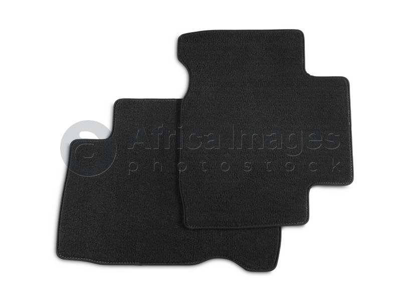 Photo of Black car floor carpets on white background, top view