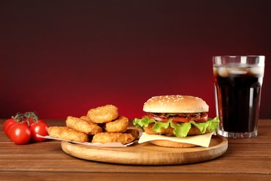 Delicious fast food menu on wooden table against red background