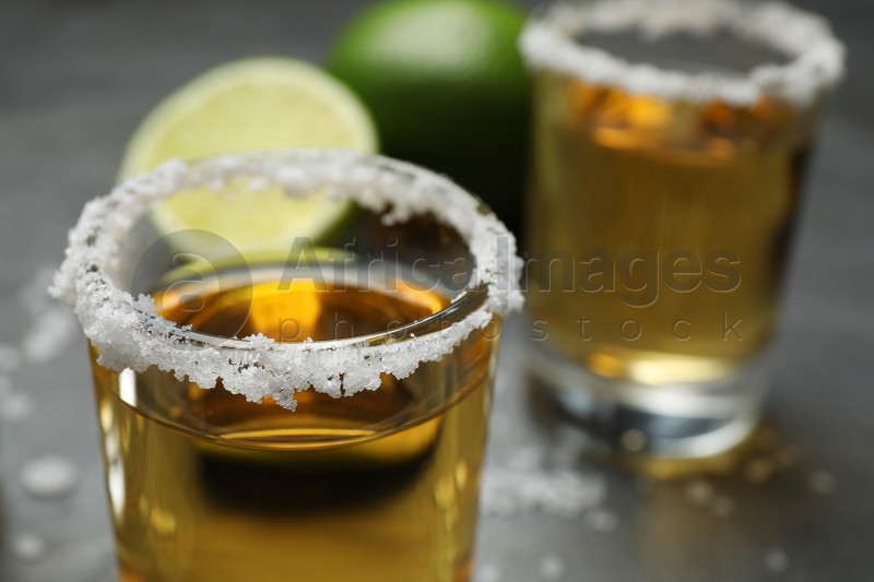 Mexican Tequila shots, with salt on grey table, closeup
