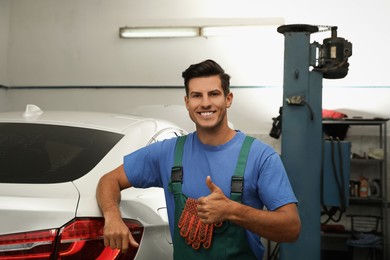 Photo of Portrait of professional mechanic at automobile repair shop