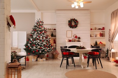 Cozy dining room interior with Christmas tree and festive decor