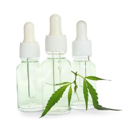 Bottles of hemp cosmetics with green leaves isolated on white