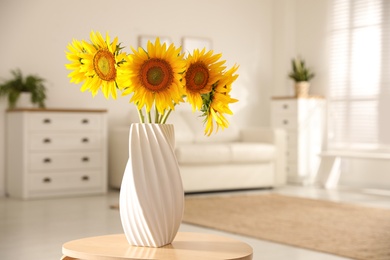 Bouquet of beautiful sunflowers in vase on table indoors. Space for text