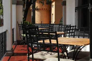 Photo of Chairs at tables on terrace near cafe