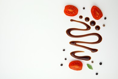 Photo of Organic balsamic vinegar and cooking ingredients on white background, flat lay. Space for text