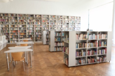 Blurred view of library interior with bookcases and tables
