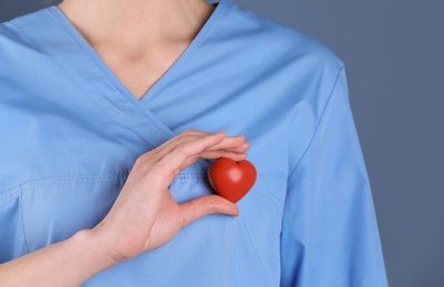 Doctor holding small heart, closeup. Prevent heart attack
