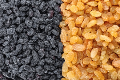 Different raisins as background, top view. Healthy dried fruit