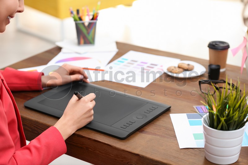 Female designer working at desk in office, closeup