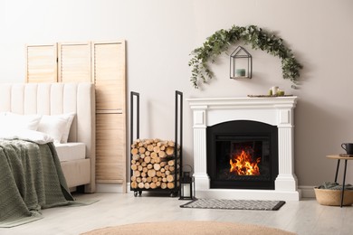Stylish room decorated with beautiful eucalyptus garland above fireplace