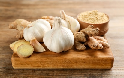 Ginger and fresh garlic on wooden table. Natural cold remedies