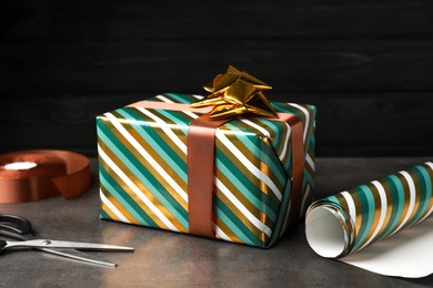 Beautifully wrapped gift box on grey table