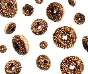 Image of Many sweet tasty donuts falling on white background