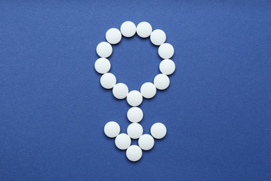 Male sign made of white pills on blue background, flat lay. Potency problems