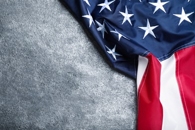 National flag of America on grey table, top view. Space for text