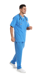 Doctor in uniform walking on white background