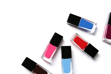 Bottles of nail polish on white background, top view