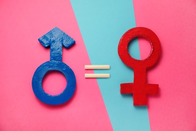 Photo of Gender equality. Equal sign, male and female symbols on color background, flat lay