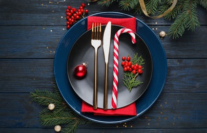 Photo of Beautiful Christmas table setting on dark wooden background, flat lay