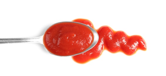 Delicious tomato sauce and spoon on white background, top view