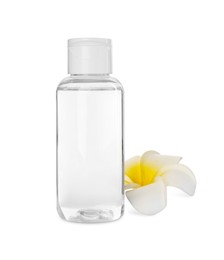 Bottle of micellar cleansing water and flower on white background