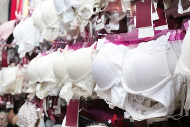 Different bras on hangers in underwear store