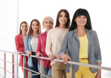 Group of ladies near handrails indoors. Women power concept