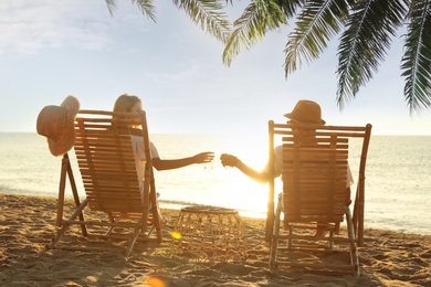 Couple enjoying their summer vacation on sandy beach 