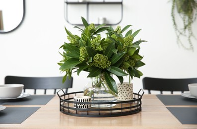 Fresh bouquet on dining table in room. Interior design