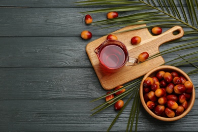 Flat lay composition with palm oil and fresh fruits on grey wooden table. Space for text