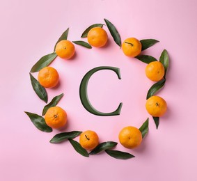 Source of Vitamin C. Fresh ripe tangerines on pink background, flat lay