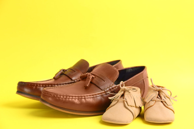Dad and son's shoes on yellow background. Happy Father's Day