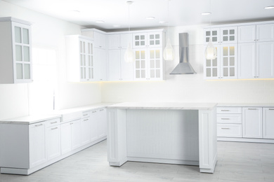 Photo of Interior of modern light kitchen with stylish furniture