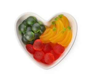 Delicious gummy fruit shaped candies on white background, top view