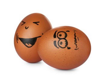 Photo of Brown eggs with drawn happy and sad faces on white background