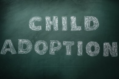 Phrase Child Adoption written with chalk on board