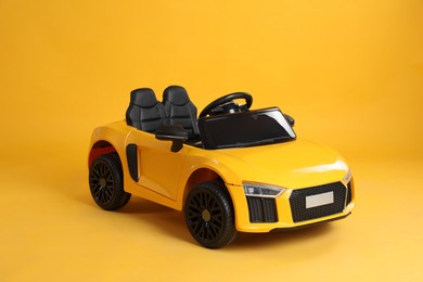 New bright toy car on yellow background