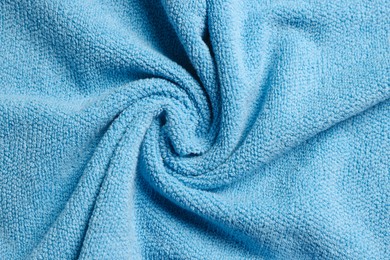 Soft crumpled blue towel as background, top view