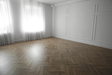 Parquet floor in light spacious empty room
