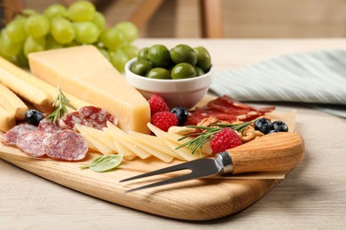 Snack set with delicious Parmesan cheese on light wooden table