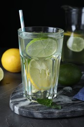 Photo of Delicious lemonade made with soda water and fresh ingredients on grey table