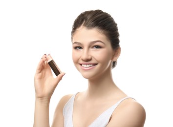 Beautiful girl with stick foundation on white background