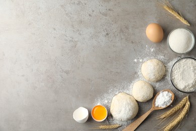 Photo of Flat lay composition with dough on grey table, space for text. Cooking pastries