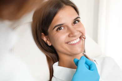 Dentist examining patient's teeth in modern clinic. Cosmetic dentistry